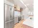 Contemporary kitchen with stainless steel refrigerator, gray cabinets, and open shelving accents at 1048 Knox Ct, Denver, CO 80204