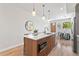 Bright open kitchen with wood cabinets, quartz countertop, stainless steel appliances, and pendant lights at 1048 Knox Ct, Denver, CO 80204