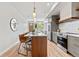 Modern kitchen featuring wood cabinets, stainless steel appliances, quartz countertops and pendant lights at 1048 Knox Ct, Denver, CO 80204