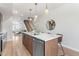 Modern kitchen with stainless steel appliances, wood cabinets, island with marble countertop, and pendant lighting at 1048 Knox Ct, Denver, CO 80204