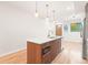 Spacious kitchen island with modern fixtures, wooden base, and convenient built-in microwave at 1048 Knox Ct, Denver, CO 80204