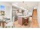 Modern kitchen with stainless steel appliances, island with seating, and bright natural light at 1048 Knox Ct, Denver, CO 80204