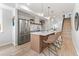 Modern kitchen with stainless steel appliances, an island, and stylish pendant lighting at 1048 Knox Ct, Denver, CO 80204