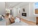 Bright living room featuring hardwood floors, modern fireplace, and an open layout to the kitchen at 1048 Knox Ct, Denver, CO 80204