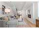 Spacious living room featuring hardwood floors, a gray sectional, a modern fireplace, and a staircase at 1048 Knox Ct, Denver, CO 80204