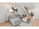 Cozy living room with hardwood floors, gray sectional, modern art, and an open floor plan at 1048 Knox Ct, Denver, CO 80204