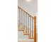 Close up of light wood stairs with black metal balusters and a light wood handrail at 1048 Knox Ct, Denver, CO 80204