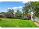 Lush backyard with a garden, mature trees, and a storage shed at 11835 W 37Th Pl, Wheat Ridge, CO 80033