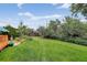 Spacious backyard featuring a lush lawn, mature trees, and landscaping at 11835 W 37Th Pl, Wheat Ridge, CO 80033
