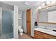 Functional bathroom featuring a shower, toilet, vanity, and storage at 11835 W 37Th Pl, Wheat Ridge, CO 80033