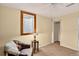 Comfortable room with a reading chair, side table with lamp, and a view of the outdoors at 11835 W 37Th Pl, Wheat Ridge, CO 80033