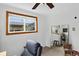 Bright bedroom featuring a large window, comfortable seating, and a mirrored corner at 11835 W 37Th Pl, Wheat Ridge, CO 80033