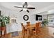 Bright dining area features a wooden table with seating for four, a ceiling fan, and natural light at 11835 W 37Th Pl, Wheat Ridge, CO 80033