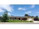 Charming home with solar panels, a well-maintained lawn, an American flag, and an attached garage at 11835 W 37Th Pl, Wheat Ridge, CO 80033