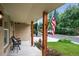 Inviting front porch with decorative columns, seating, and a view of the lush front yard at 11835 W 37Th Pl, Wheat Ridge, CO 80033