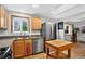 Bright kitchen with skylights, stainless steel appliances, and a butcher block island at 11835 W 37Th Pl, Wheat Ridge, CO 80033
