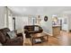 Cozy living room with hardwood floors, neutral paint, and views into the kitchen and entryway at 11835 W 37Th Pl, Wheat Ridge, CO 80033