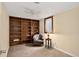 Inviting living room with built-in shelving, a cozy chair, and natural light at 11835 W 37Th Pl, Wheat Ridge, CO 80033