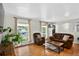 Spacious living room with hardwood floors, large windows, and comfortable seating furniture at 11835 W 37Th Pl, Wheat Ridge, CO 80033
