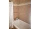 The bathroom has a large soaking tub with a shower curtain at 2860 Ames St, Wheat Ridge, CO 80214