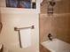 Well-maintained bathroom featuring a tiled shower, towel rack, and essential fixtures at 2860 Ames St, Wheat Ridge, CO 80214