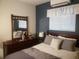 This bedroom features a full bed, white blinds, mirror and dresser at 2860 Ames St, Wheat Ridge, CO 80214