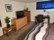 A bedroom includes a TV, furnishings, and a window for a comfortable living space at 2860 Ames St, Wheat Ridge, CO 80214