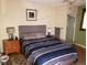 Bedroom with a queen bed, lamps, and an ensuite bathroom with shower at 2860 Ames St, Wheat Ridge, CO 80214