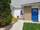 Inviting entrance with a blue door and a well-maintained walkway with lush greenery at 2860 Ames St, Wheat Ridge, CO 80214