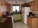 Kitchen featuring wooden cabinetry, appliances, and ample counter space at 2860 Ames St, Wheat Ridge, CO 80214