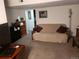 Comfortable living room with futon, shelving, and neutral carpet at 2860 Ames St, Wheat Ridge, CO 80214