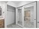 Bathroom vanity with a large mirror and sliding closet doors looking into shower at 10890 W Evans Ave # 1G, Lakewood, CO 80227