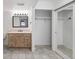 Bathroom vanity with a large mirror and sliding closet doors at 10890 W Evans Ave # 1G, Lakewood, CO 80227