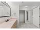 Bathroom vanity with a large mirror and sliding closet doors at 10890 W Evans Ave # 1G, Lakewood, CO 80227