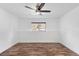 Bedroom featuring hardwood floors, a ceiling fan, and a sunlit window at 10890 W Evans Ave # 1G, Lakewood, CO 80227