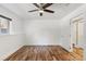 Bedroom featuring hardwood floors, a ceiling fan, and a closet at 10890 W Evans Ave # 1G, Lakewood, CO 80227