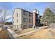 Exterior corner view of the apartment building showcasing the side and back with landscaping at 10890 W Evans Ave # 1G, Lakewood, CO 80227