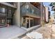 Exterior view of the unit with stairs, a balcony, and a sign with agent information at 10890 W Evans Ave # 1G, Lakewood, CO 80227