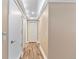 Hallway featuring hardwood floors and multiple closet doors for ample storage at 10890 W Evans Ave # 1G, Lakewood, CO 80227