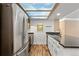 Spacious kitchen featuring stainless appliances, granite countertops, and a unique sky light at 10890 W Evans Ave # 1G, Lakewood, CO 80227