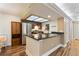 Open kitchen with stainless steel appliances, granite counters, and stylish wood flooring at 10890 W Evans Ave # 1G, Lakewood, CO 80227