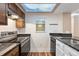 Close-up of kitchen area with stainless steel stove and granite countertops at 10890 W Evans Ave # 1G, Lakewood, CO 80227