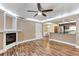 Inviting living room with hardwood floors, a cozy fireplace, and an open layout to the kitchen at 10890 W Evans Ave # 1G, Lakewood, CO 80227