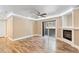 Cozy living room featuring wood floors, a fireplace, and a sliding glass door at 10890 W Evans Ave # 1G, Lakewood, CO 80227