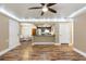 Open-concept living room featuring hardwood floors, breakfast bar to kitchen and dining room at 10890 W Evans Ave # 1G, Lakewood, CO 80227