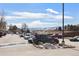View of a parking lot with parked cars and distant mountain views on a clear day at 10890 W Evans Ave # 1G, Lakewood, CO 80227
