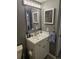 This modern bathroom includes a white vanity, sink, and mirror at 8600 E Alameda Ave # 105, Denver, CO 80247