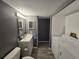 Well-lit bathroom with washer/dryer and modern fixtures at 8600 E Alameda Ave # 105, Denver, CO 80247