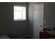 Bedroom featuring a window with blinds and a closed door at 8600 E Alameda Ave # 105, Denver, CO 80247