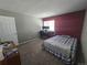 The bedroom has grey carpet, a computer setup, and a blue bedspread at 8600 E Alameda Ave # 105, Denver, CO 80247